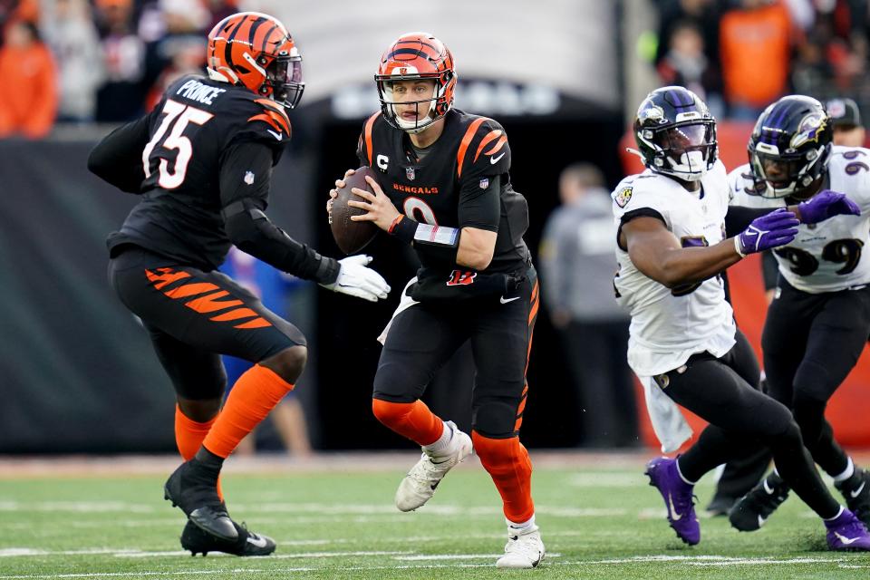 Cincinnati Bengals quarterback Joe Burrow (9) runs out of the pocket in the fourth quarter during a Week 16 NFL game against the Baltimore Ravens, Sunday, Dec. 26, 2021, at Paul Brown Stadium in Cincinnati. The Cincinnati Bengals defeated the Baltimore Ravens, 41-21. 