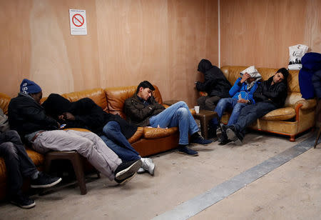Migrants rest in the common area at the reception center for migrants and refugees near porte de La Chapelle in the north of Paris, France, November 25, 2016. REUTERS/Jacky Naegelen