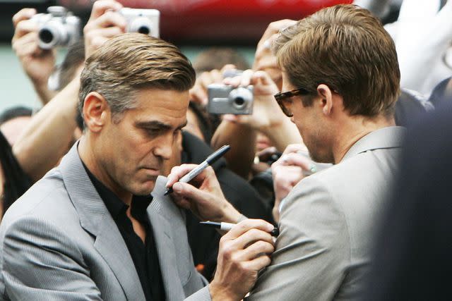 <p>GABRIEL BOUYS/AFP/Getty</p> George Clooney and Brad Pitt in 2007