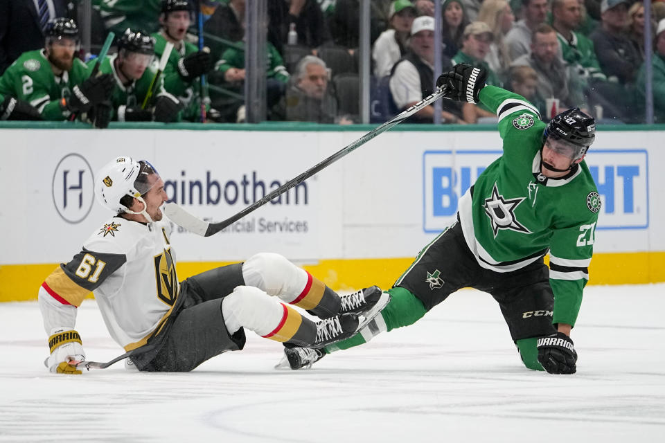 Vegas Golden Knights right wing Mark Stone (61) and Dallas Stars left wing Mason Marchment (27) collide during the first period of an NHL hockey game, Saturday, Dec. 9, 2023, in Dallas. (AP Photo/Julio Cortez)