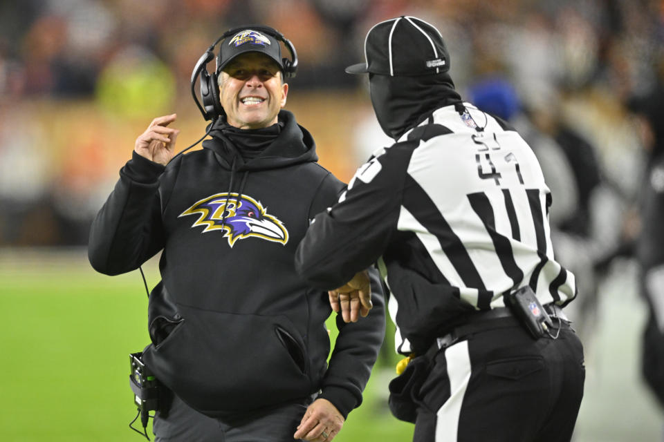 Baltimore Ravens head coach John Harbaugh meets with side judge Boris Cheek (41) during the first half of an NFL football game, Saturday, Dec. 17, 2022, in Cleveland. (AP Photo/David Richard)