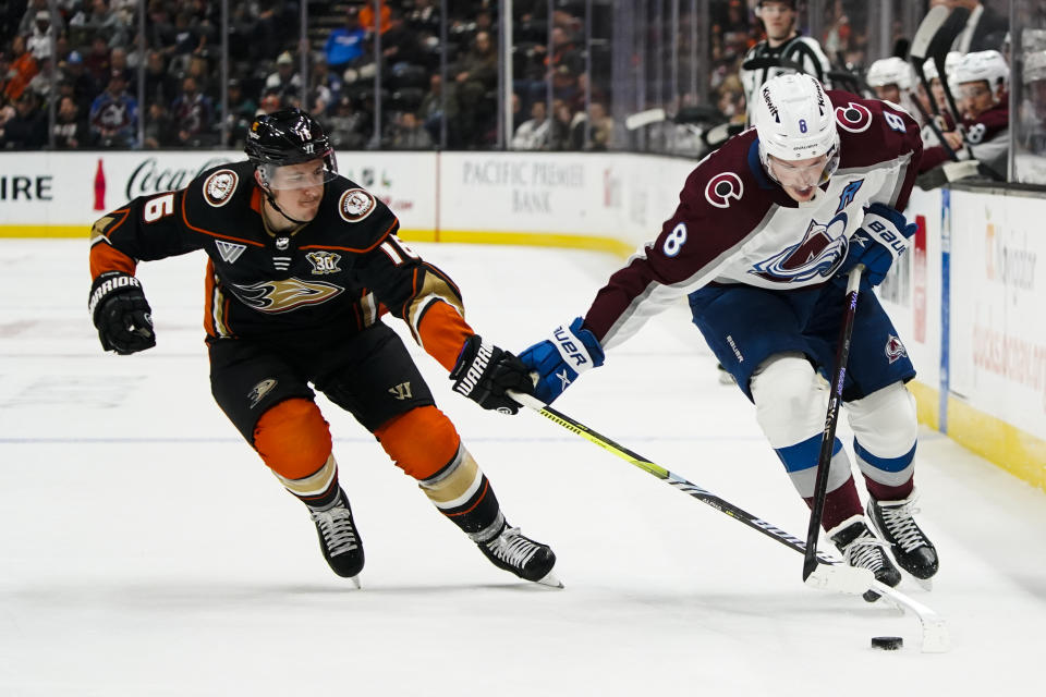 Colorado Avalanche defenseman Cale Makar, right, and Anaheim Ducks center Ryan Strome vie for the puck during the second period of an NHL hockey game Saturday, Dec. 2, 2023, in Anaheim, Calif. (AP Photo/Ryan Sun)