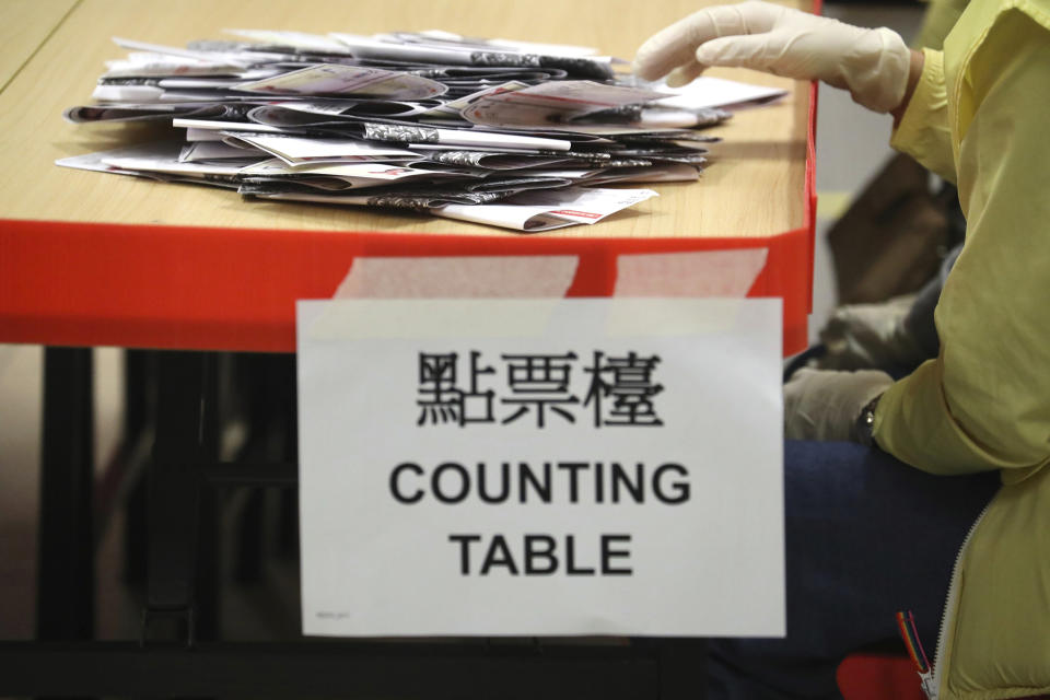 An election worker prepares to count votes at a polling station in Hong Kong, Sunday, Nov. 24, 2019. Voters in Hong Kong turned out in droves on Sunday in district council elections seen as a barometer of public support for pro-democracy protests that have rocked the semi-autonomous Chinese territory for more than five months. (AP Photo/Ng Han Guan)