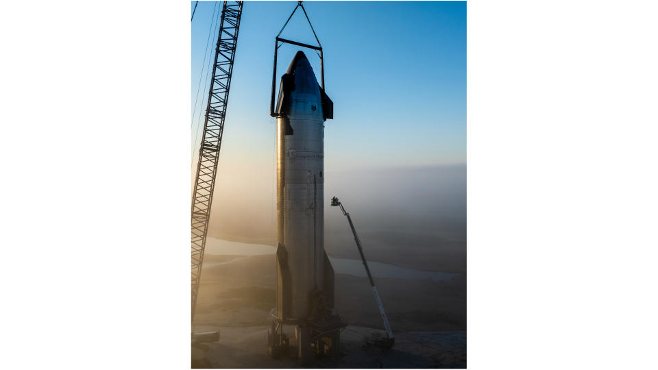 a large silver spacecraft is moved onto the launch pad