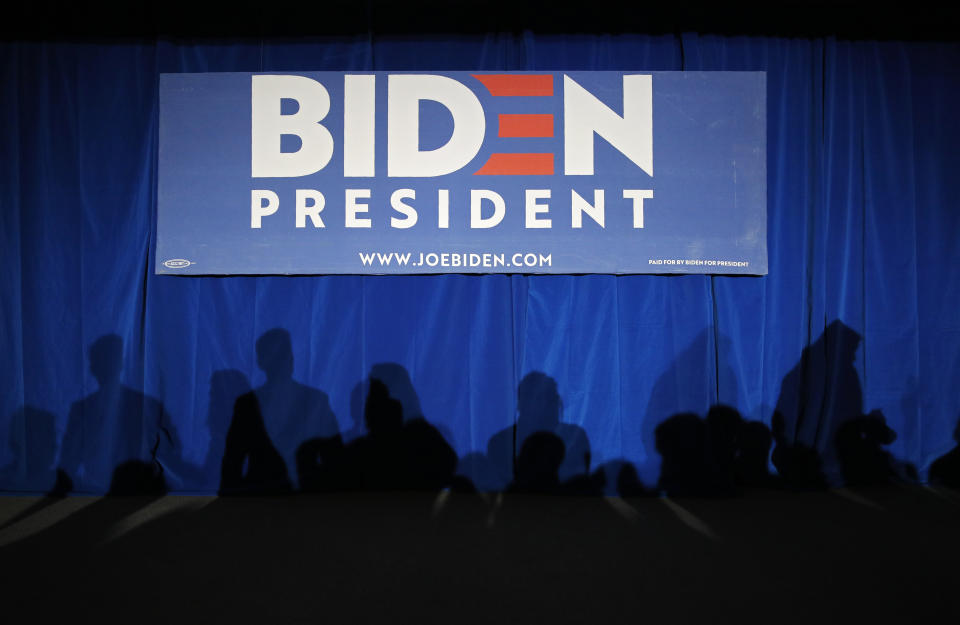 People cast a shadow while waiting to meet with former Vice President and Democratic presidential candidate Joe Biden at a campaign event, Saturday, Nov. 16, 2019, in Las Vegas. (AP Photo/John Locher)