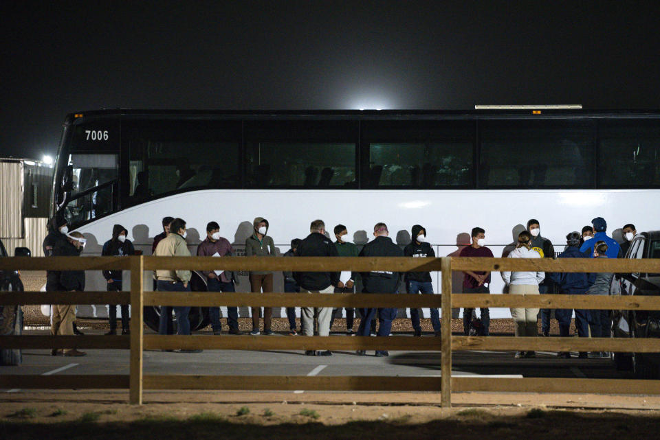 FILE - In this Sunday, March 14, 2021, file photo, migrant children and teenagers are processed after entering the site of a temporary holding facility south of Midland, Texas. Teenagers began arriving Sunday at a converted camp for oilfield workers where volunteers from the American Red Cross will care for them. (Eli Hartman/Odessa American via AP, File)