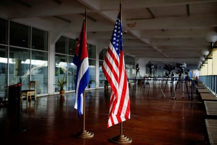 FILE PHOTO: U.S. and Cuban flags are seen before a ceremony for the arrival of Carnival cruise ship ms Veendam during its first trip to Cuba in Havana, Cuba, December 28, 2017. REUTERS/Alexandre Meneghini