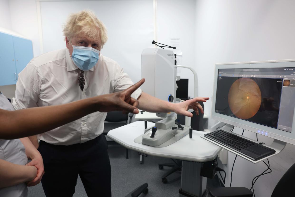 Britain's Prime Minister Boris Johnson, gestures during a visit to Finchley Memorial Hospital, in North London, Tuesday, Jan. 18, 2022. (Ian Vogler, Pool Photo via AP)