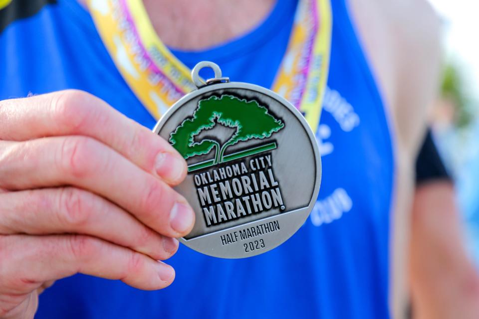 A runner shows off his medal at the Oklahoma City Memorial Marathon on Sunday.