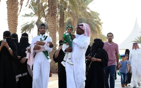 Saudi families arrive outside a stadium to attend an event in the capital Riyadh  - Credit: AFP