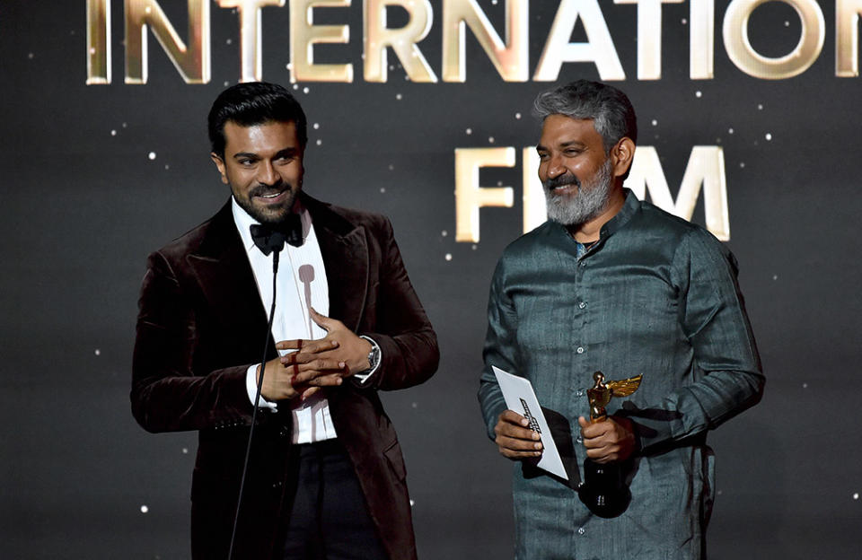 (L-R) Ram Charan and S. S. Rajamouli accept the Best International Film award for 'RRR' onstage during the Hollywood Critics Association's 2023 HCA Film Awards at Beverly Wilshire, A Four Seasons Hotel on February 24, 2023 in Beverly Hills, California.