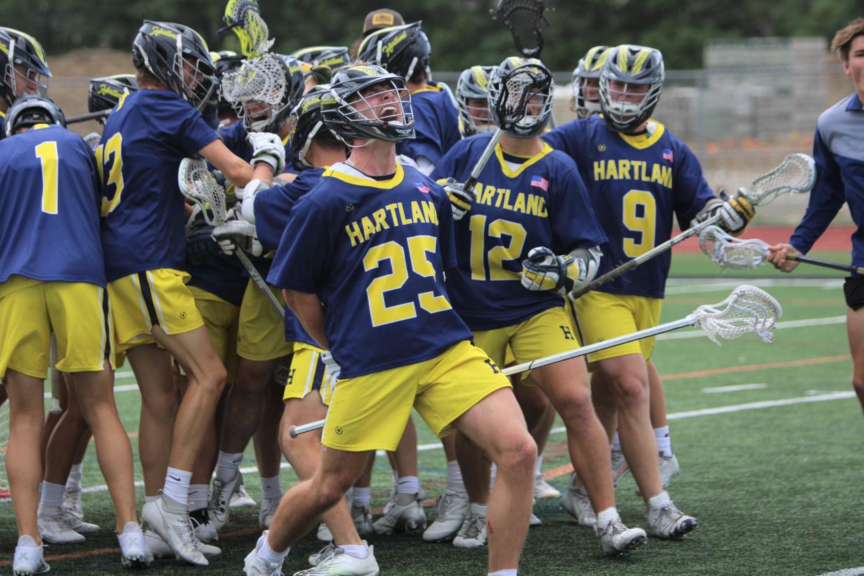 Hartland players celebrate a state semifinal lacrosse victory over Birmingham Brother Rice Thursday, June 6, 2024 at Troy High School.