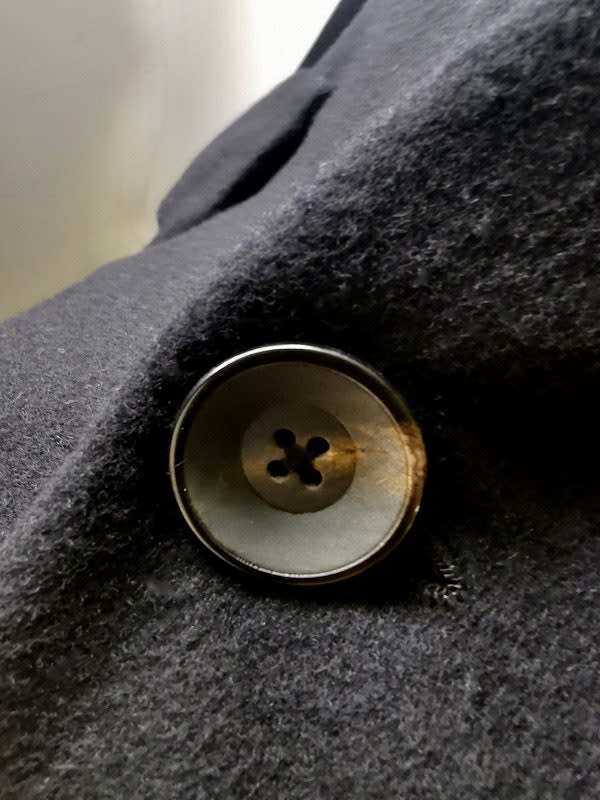 A pure horn button on a Geoffrey B. Small jacket.