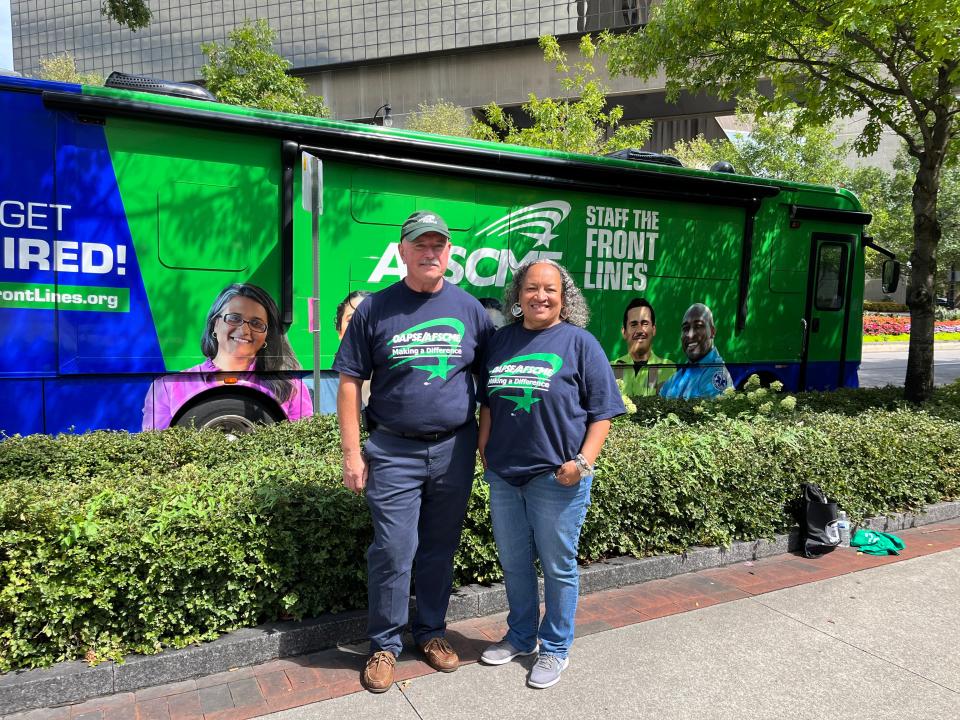 (From left to right) Ohio Association of Public School Employees (OAPSE) Vice President Mike Lang and OAPSE President Lois Carson welcome the 'Staff the Front Lines' rally bus to town.