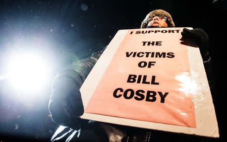 A woman protests against Bill Cosby, outside the Centre In The Square venue where the comedian is performing, in Kitchener, January 7, 2015. REUTERS/Mark Blinch