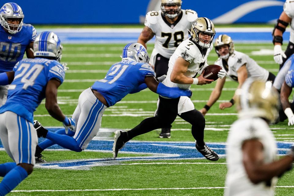 Lions defensive back Tracy Walker tackles Saints quarterback Taysom Hill during the first half at Ford Field on Sunday, Oct. 4, 2020.