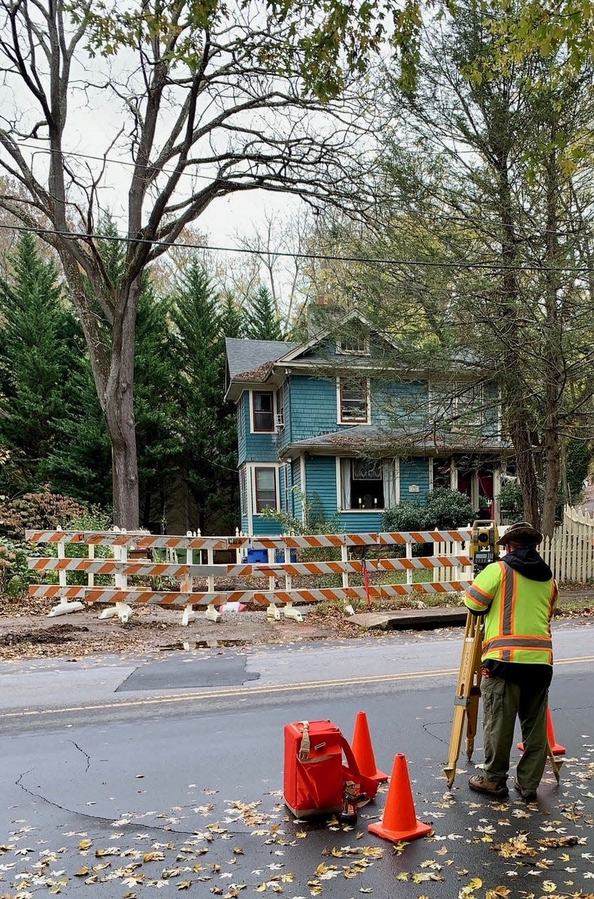 Generally speaking, experts say, pay increases with training and education. In this November 2021 file photo, a worker with McGill Associates, an Asheville civil engineering firm, surveys a sinkhole location on Montford Avenue.