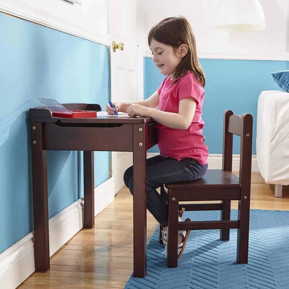 If you don't want a big bulky desk, this lift-top desk has a hidden space to store everything from crayons to coloring books. It comes with a chair so you don't have to worry about finding one that matches. <a href="https://amzn.to/3fQJRsl" target="_blank" rel="noopener noreferrer">Find it for $87 at Amazon</a>. Keep in mind that it's on back order, shipping out a little later than Amazon's usual two days.