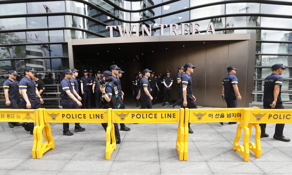 South Korean police officers patrol for possible rallies against Japan in front of a building which houses Japanese embassy in Seoul, South Korea, Thursday, Aug. 1, 2019. Police say a 72-year-old South Korean man is in critical condition after setting himself ablaze in downtown Seoul, apparently to express his anger toward Japan amid worsening tensions between countries over trade and wartime history. (AP Photo/Ahn Young-joon)