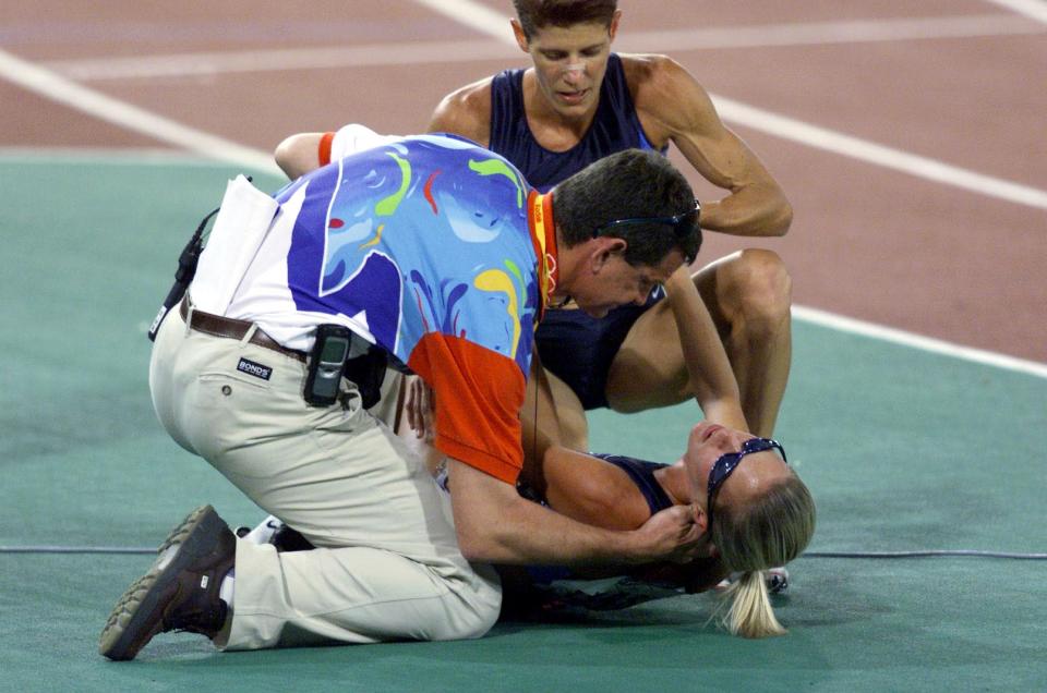 30 Sep 2000: Suzy Favor Hamilton of the USA is attended to by a doctor and team mate Marla Runyan after a fall, in the final of the Women's 1500m at the Sydney 2000 Olympic Games, held at Stadium Australia, Homebush Bay in Sydney, Australia. DIGITAL IMAGE Mandatory Credit: Sean Garnsworthy/ALLSPORT