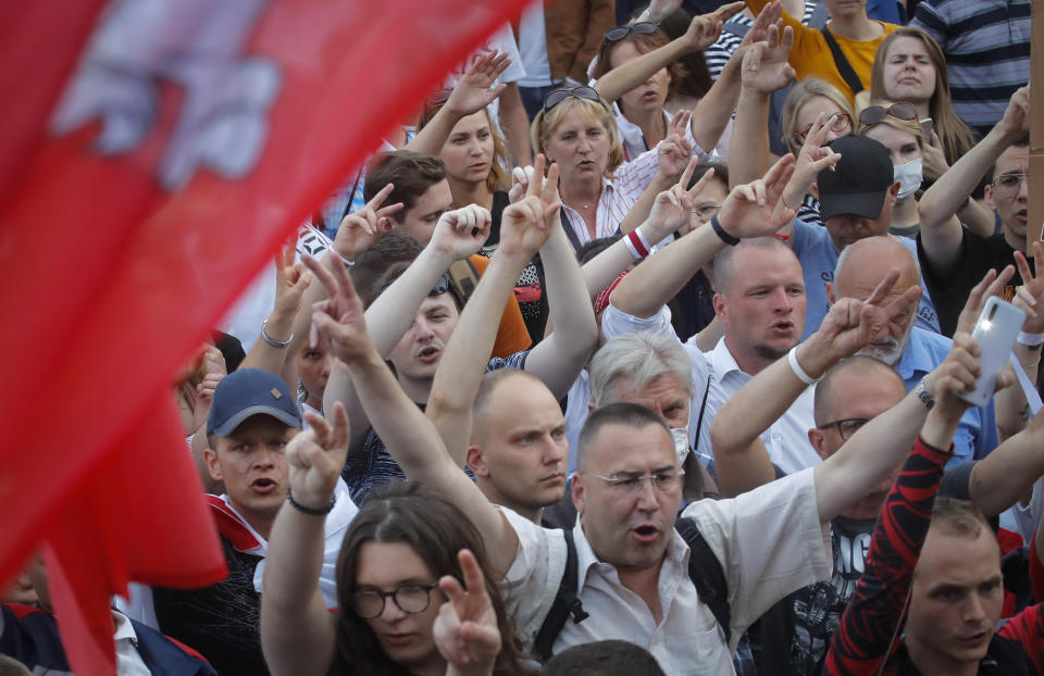 Belarusian opposition supporters shout slogans during a protest rally in front of the government building at Independent Square in Minsk, Belarus, Tuesday, Aug. 18, 2020. Workers at more state-controlled companies and factories took part in the strike that began the day before and has encompassed several truck and tractor factories, a huge potash factory that accounts for a fifth of the world's potash fertilizer output and is the nation's top cash earner, state television and the country's most prominent theater. (AP Photo/Dmitri Lovetsky)