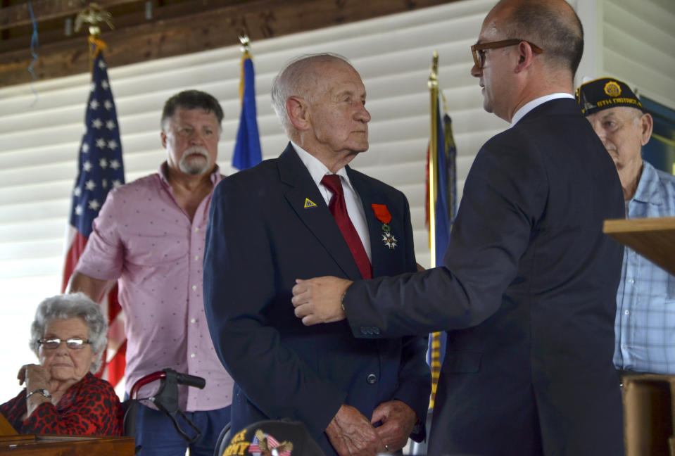 Consul General of France to the Midwest Guillaume Lacroix, right, stands by WWII veteran Jimmie H. Royer to hug after Lacroix awarded Royer France's Legion of Honor during a ceremony at VFW Post 346 in Terre Haute, Ind., Sunday, Sept. 29, 2019. The 94-year-old World War II veteran from western Indiana received the medal Sunday for his wartime service. (Austen Leake/The Tribune-Star via AP)