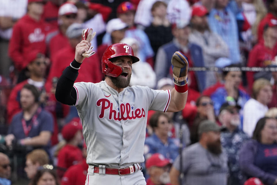 Philadelphia Phillies' Bryce Harper celebrates after scoring on a hit by Jean Segura in Game 1 against the Cardinals. (AP Photo/Jeff Roberson)