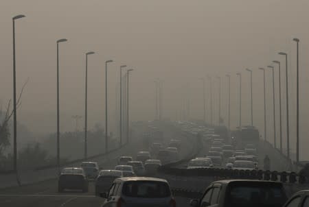 Vehicles drive through the smog in New Delhi