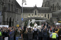 Pope Francis waves to the waiting crowds on Christchurch, Dublin as he travels in the Popemobile during his visit to Ireland, Saturday, Aug. 25, 2018. (Brian Lawless/PA via AP)