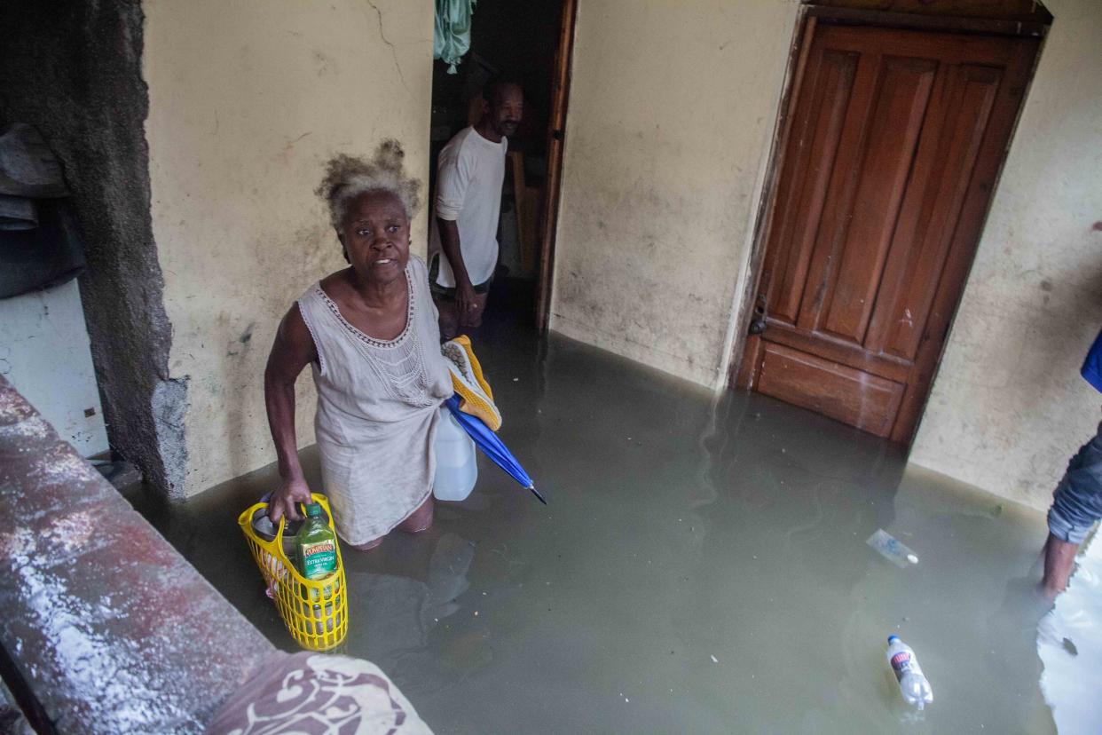 People look for whatever can be recovered in their flooded house as heavy rain brought by tropical storm Grace hits Haitians just after a 7.2-magnitude earthquake struck Haiti on Aug. 17, 2021, in Les Cayes, Haiti. Rescue workers have been working among destroyed homes since the quake struck on Saturday and so far there are 1,419 dead and 6,000 wounded. The epicenter was located about 100 miles west of the capital city Port-au-Prince.