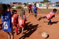 Children play soccer in the neighborhood of Estrutural in Brasilia