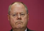 Social Democratic Party (SPD) top candidate Peer Steinbrueck attends a news conference at the SPD headquarters in Berlin, September 23, 2013. Germany's Angela Merkel began trying to persuade her centre-left rivals to keep her in power on Monday after her conservatives notched up their best election result in more than two decades but fell short of an absolute majority. (REUTERS/Ralph Orlowski)