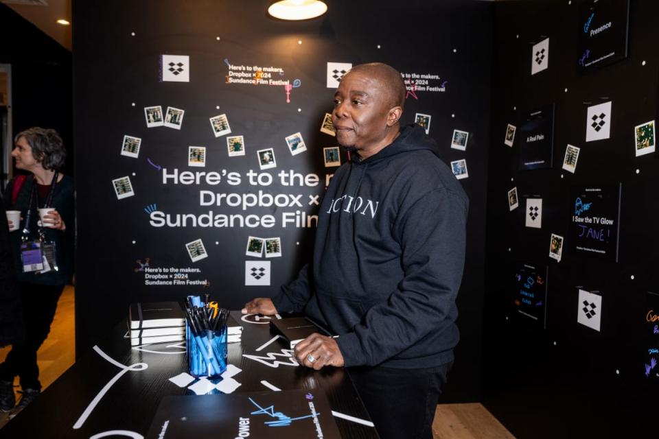 Yance Ford stands behind a desk at tehe IndieWire Sundance Studio