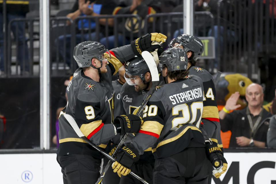 Vegas Golden Knights centers Jack Eichel (9) and Chandler Stephenson (20) celebrate with Vegas Golden Knights left wing William Carrier (28) after Carrier's goal against the Montreal Canadiens during the second period of an NHL hockey game, Monday, Oct. 30, 2023, in Las Vegas. (AP Photo/Ian Maule)