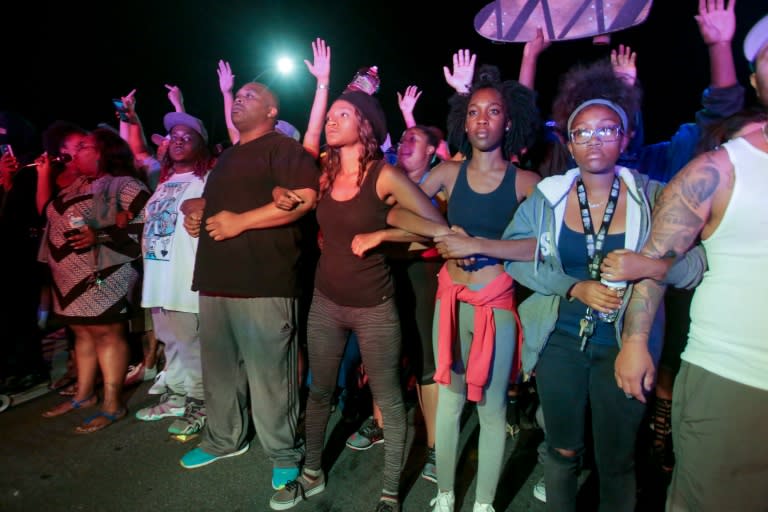 Protesters lock arms in front of a police line in El Cajon, a suburb of San Diego, California in response to a police shooting the night before of Ugandan refugee Alfred Olango