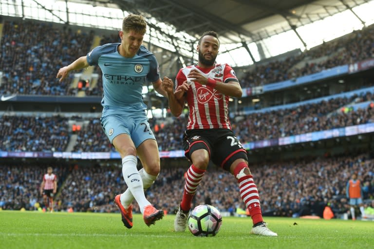 Southampton's midfielder Nathan Redmond (R) clashes with Manchester City's defender John Stones on October 23, 2016