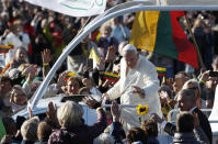 Pope Francis greets people as he arrives for a Mass at Santakos Park, in Kaunas, Lithuania, Sunday, Sept. 23, 2018. Francis is paying tribute to Lithuanians who suffered and died during Soviet and Nazi occupations on the day the country remembers the near-extermination of its centuries-old Jewish community during the Holocaust. (AP Photo/Mindaugas Kulbis)