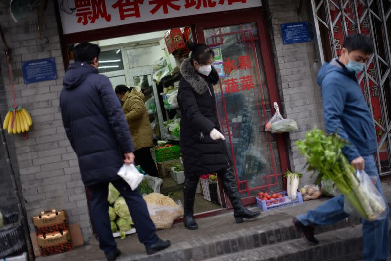 Residents buy food in a greengrocer's shop at a hutong, as the country is hit by an outbreak of the novel coronavirus, in Beijing