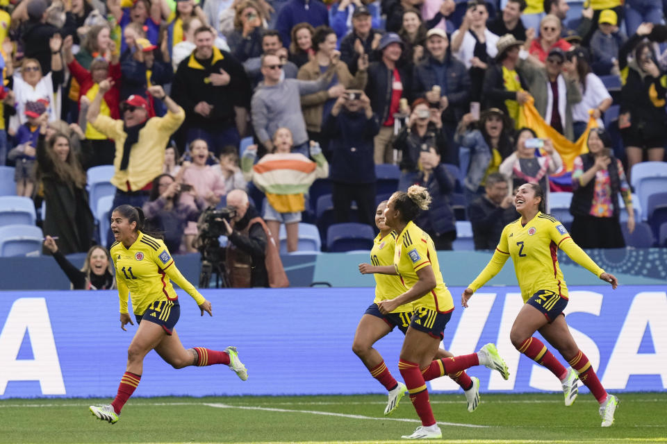Colombia's Catalina Usme, left, celebrates after scoring the opening goal on a penalty kick during the Women's World Cup Group H soccer match between Colombia and South Korea at the Sydney Football Stadium in Sydney, Australia, Tuesday, July 25, 2023. (AP Photo/Rick Rycroft)