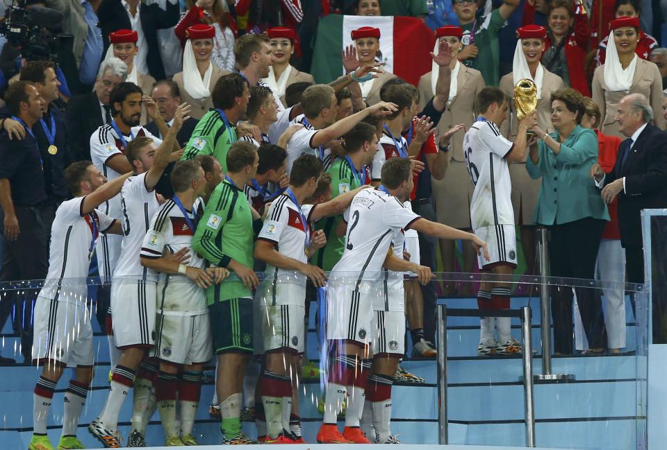 Brazil's President Rousseff hands the World Cup trophy over to Germany's captain Lahm after the 2014 World Cup final against Argentina in Rio de Janeiro