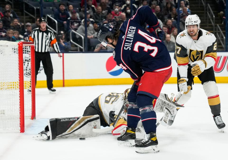 Sun., Mar. 13, 2022; Columbus, Ohio, USA; Columbus Blue Jackets center Cole Sillinger (34) attempts a shot on Vegas Golden Knights goaltender Logan Thompson (36) during the first period of a NHL game between the Columbus Blue Jackets and the Vegas Golden Knights at Nationwide Arena. 