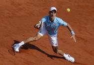 Novak Djokovic of Serbia returns the ball to Rafael Nadal of Spain during their men's singles final match at the French Open Tennis tournament at the Roland Garros stadium in Paris June 8, 2014. REUTERS/Gonzalo Fuentes