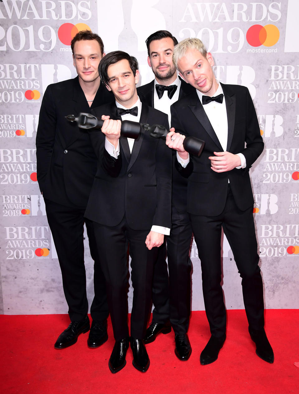 Matthew Healy, Ross MacDonald, George Daniel and Adam Hann of The 1975 with their Best British Group and Mastercard British Album of the Year Brit Awards