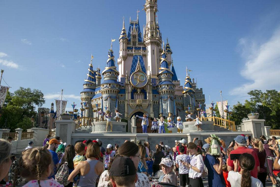 FILE - Performers dressed as Mickey Mouse, Minnie Mouse, Goofy, Donald Duck and Daisy Duck entertain visitors at Cinderella Castle at Walt Disney World Resort in Lake Buena Vista, Florida, on April 18, 2022. Florida lawmakers will move to increase state control of Walt Disney World’s private government, according to a notice published Friday, Jan. 6, 2023, that marks the latest development in a feud over a law critics call “Don’t Say Gay.” (AP Photo/Ted Shaffrey, File)