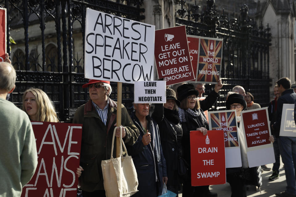 Brexit leave the European Union supporters protest with placards outside the Houses of Parliament in London, Tuesday, Oct. 22, 2019. British Prime Minister Boris Johnson's European Union divorce bill faces two votes Tuesday, with lawmakers first being asked to approve it in principle, followed by a vote on the government's schedule for debate and possible amendments. (AP Photo/Matt Dunham)