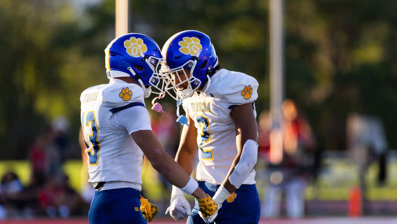 Orem’s Kaue Akana and Roger Saleapaga celebrate during their high school football season opener against East at East High School in Salt Lake City on Friday, Aug. 11, 2023. Orem won the game 21-20.