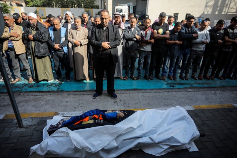 Relatives and friends pray by the body of Saif Abu Taha, a staff member of World Central Kitchen who was killed as Israeli airstrikes hit a convoy that was delivering food aid in Gaza. Photo by Ismael Mohamad/UPI