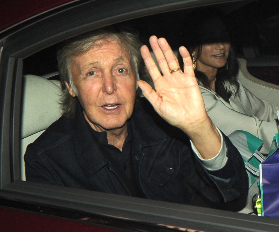 paul mccartney in a car waving