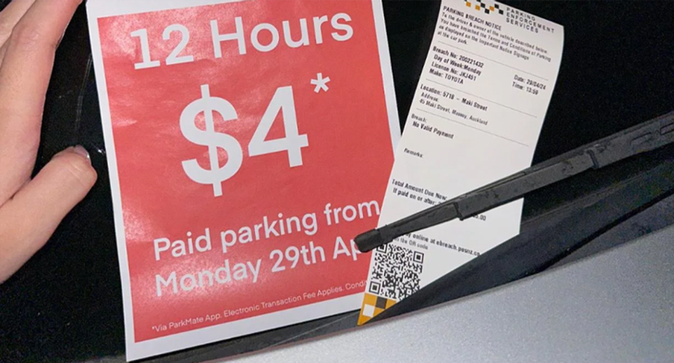 The $85 parking fine as well as a Wilson Parking leaflet which reads, '12 hours for $4'. 