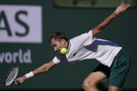 Daniil Medvedev, of Russia, returns a shot to Grigor Dimitrov, of Bulgaria, at the BNP Paribas Open tennis tournament Wednesday, Oct. 13, 2021, in Indian Wells, Calif. (AP Photo/Mark J. Terrill)